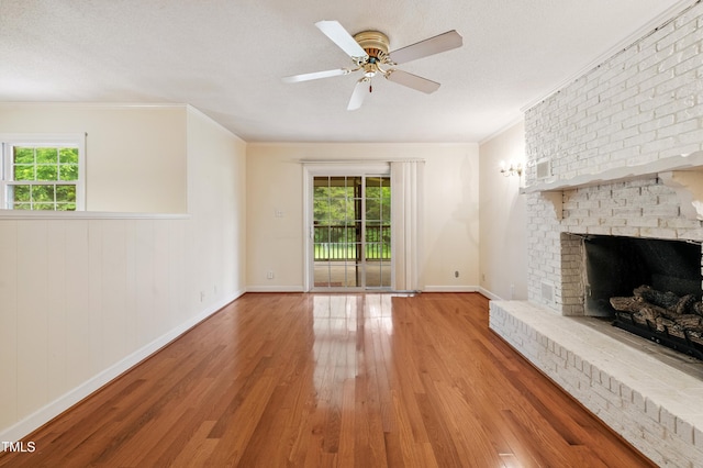 410 Sherron Rd, Durham, NC 27703 - unfurnished living room featuring wood finished floors, a fireplace, ceiling fan, and ornamental molding