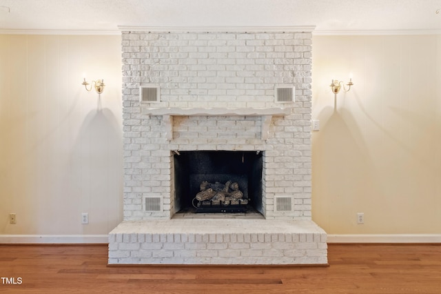 410 Sherron Rd, Durham, NC 27703 - detailed view of wood finished floors, ornamental molding, and a fireplace