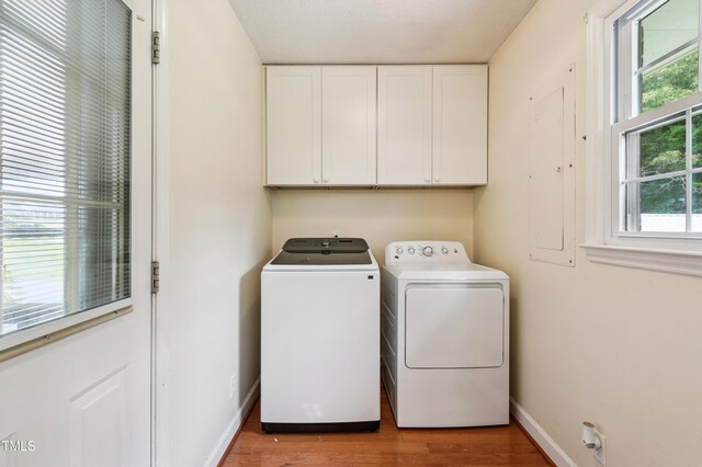 410 Sherron Rd, Durham, NC 27703 - laundry room featuring independent washer and dryer, cabinet space, and wood finished floors