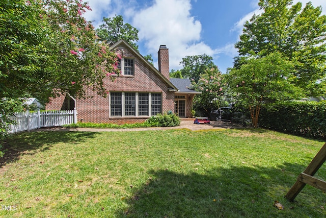 2328 Byrd St, Raleigh, NC 27608 - rear view of property with brick siding, a chimney, and a patio