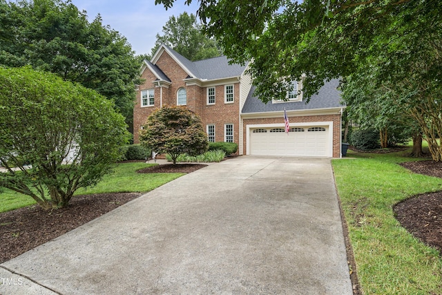 102 Glenmore Rd, Cary, NC 27519 - colonial inspired home with brick siding, driveway, a shingled roof, and a front yard