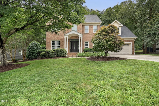 102 Glenmore Rd, Cary, NC 27519 - view of front facade featuring concrete driveway, brick siding, an attached garage, and a front yard