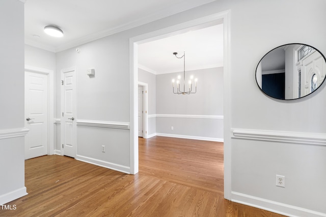 102 Glenmore Rd, Cary, NC 27519 - hall featuring wood finished floors, a chandelier, and crown molding