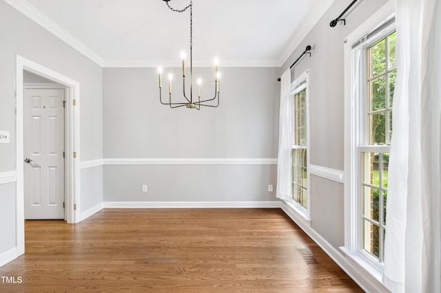 102 Glenmore Rd, Cary, NC 27519 - unfurnished dining area featuring a chandelier, wood finished floors, and ornamental molding