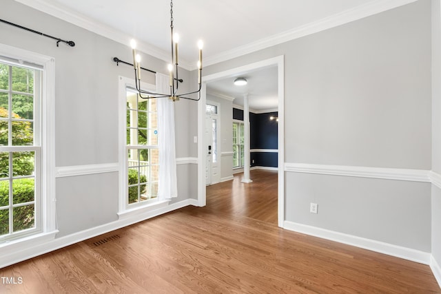102 Glenmore Rd, Cary, NC 27519 - unfurnished dining area with a chandelier, wood finished floors, and ornamental molding