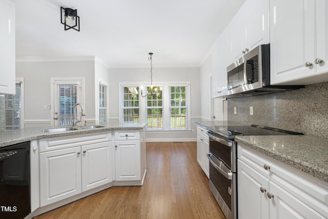 102 Glenmore Rd, Cary, NC 27519 - kitchen featuring stainless steel appliances, light wood finished floors, a chandelier, white cabinetry, and backsplash