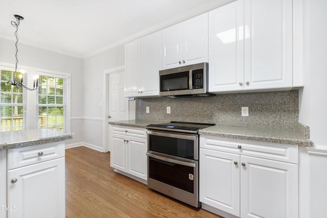 102 Glenmore Rd, Cary, NC 27519 - kitchen featuring stainless steel appliances, a chandelier, light wood finished floors, tasteful backsplash, and white cabinets