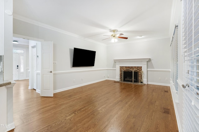 102 Glenmore Rd, Cary, NC 27519 - unfurnished living room with ceiling fan, wood finished floors, ornamental molding, and a fireplace