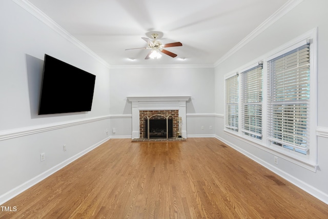 102 Glenmore Rd, Cary, NC 27519 - unfurnished living room featuring a ceiling fan, ornamental molding, wood finished floors, and a brick fireplace