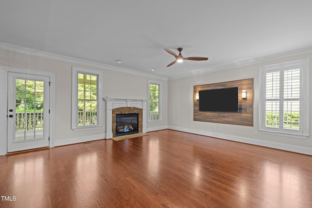 3005 Canopy Woods Dr, Apex, NC 27539 - unfurnished living room featuring healthy amount of natural light, ceiling fan, wood finished floors, and crown molding