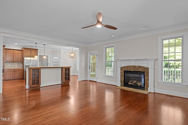3005 Canopy Woods Dr, Apex, NC 27539 - unfurnished living room featuring a ceiling fan, healthy amount of natural light, wood finished floors, a fireplace, and ornamental molding