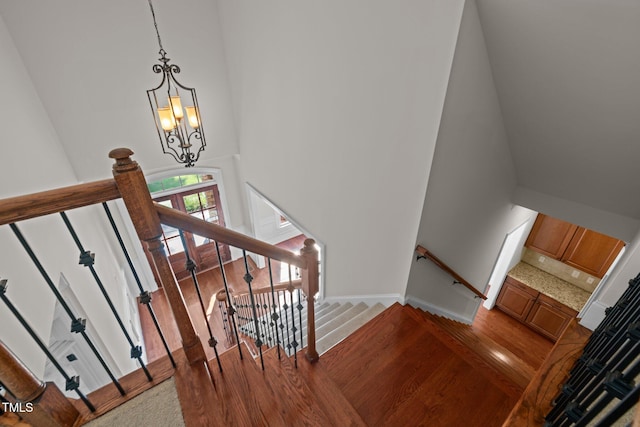 3005 Canopy Woods Dr, Apex, NC 27539 - stairs featuring wood finished floors, a high ceiling, and a chandelier