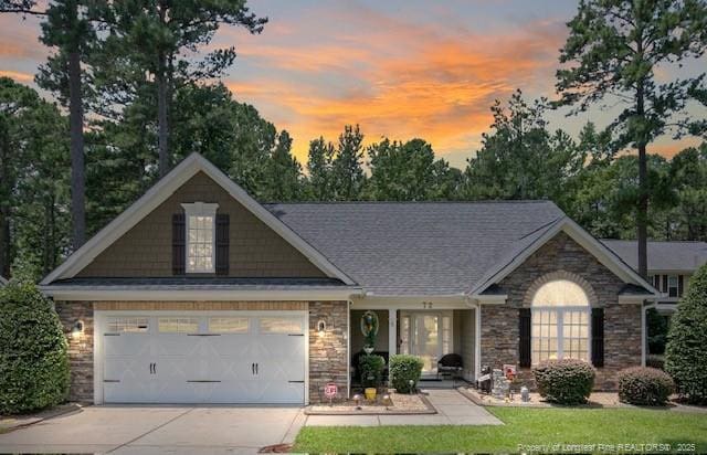 72 Orchard Falls Dr, Spring Lake, NC 28390 - view of front of property featuring stone siding, driveway, an attached garage, and a porch