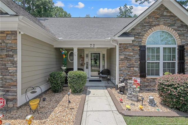 72 Orchard Falls Dr, Spring Lake, NC 28390 - view of exterior entry featuring stone siding, a shingled roof, and covered porch