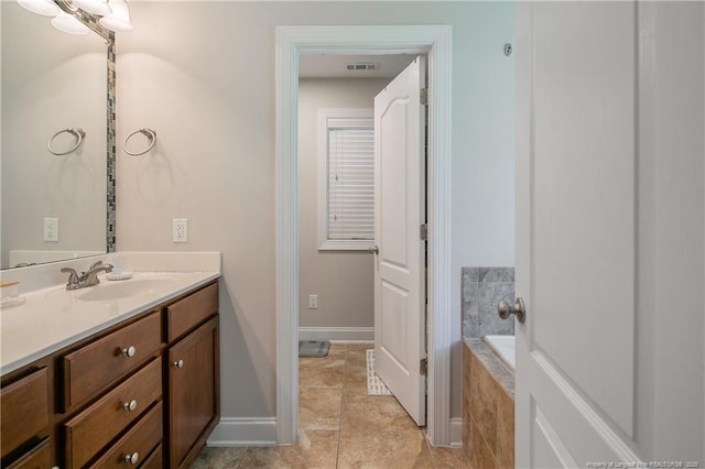 72 Orchard Falls Dr, Spring Lake, NC 28390 - bathroom with vanity, a garden tub, and tile patterned flooring