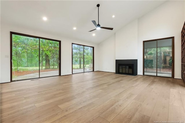 916 Rays Bridge Rd, Whispering Pines, NC 28327 - unfurnished living room featuring a ceiling fan, a glass covered fireplace, light wood-type flooring, high vaulted ceiling, and recessed lighting