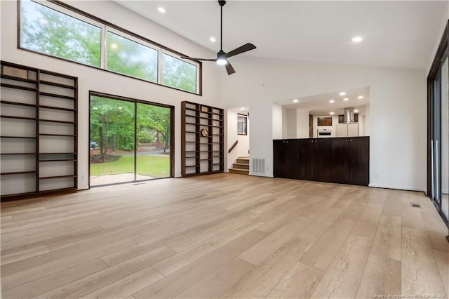 916 Rays Bridge Rd, Whispering Pines, NC 28327 - unfurnished living room featuring ceiling fan, light wood finished floors, stairs, high vaulted ceiling, and recessed lighting
