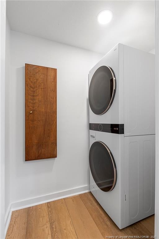 916 Rays Bridge Rd, Whispering Pines, NC 28327 - laundry area featuring estacked washer and dryer and wood finished floors