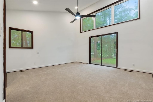 916 Rays Bridge Rd, Whispering Pines, NC 28327 - spare room featuring carpet floors, a ceiling fan, a towering ceiling, and recessed lighting