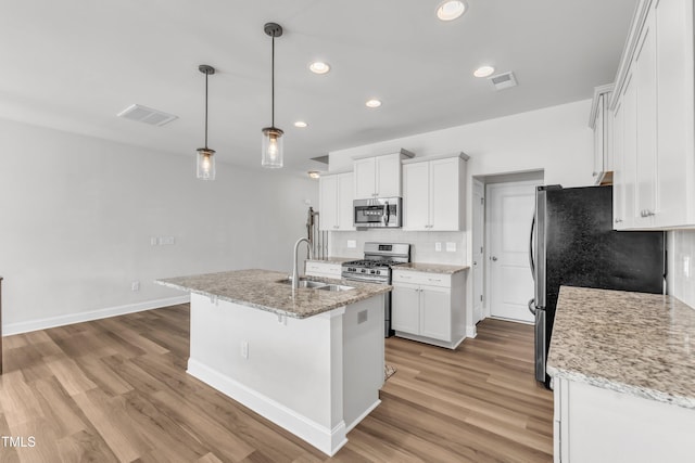 1126 Apogee Dr, Durham, NC 27713 - kitchen featuring stainless steel appliances, light wood-type flooring, white cabinets, and recessed lighting