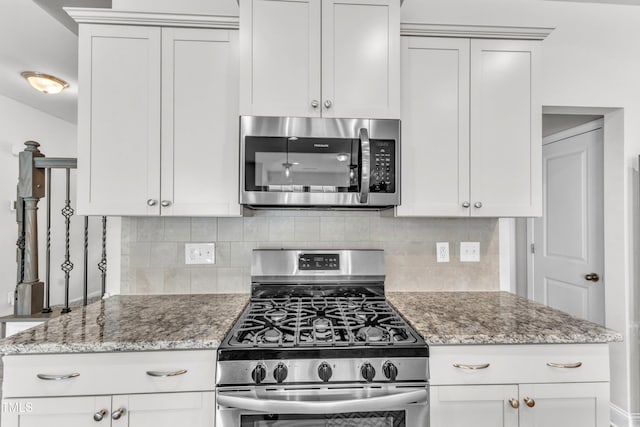 1126 Apogee Dr, Durham, NC 27713 - kitchen featuring appliances with stainless steel finishes, decorative backsplash, and light stone counters