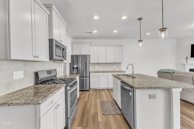 1126 Apogee Dr, Durham, NC 27713 - kitchen with appliances with stainless steel finishes, open floor plan, light wood-style flooring, recessed lighting, and tasteful backsplash