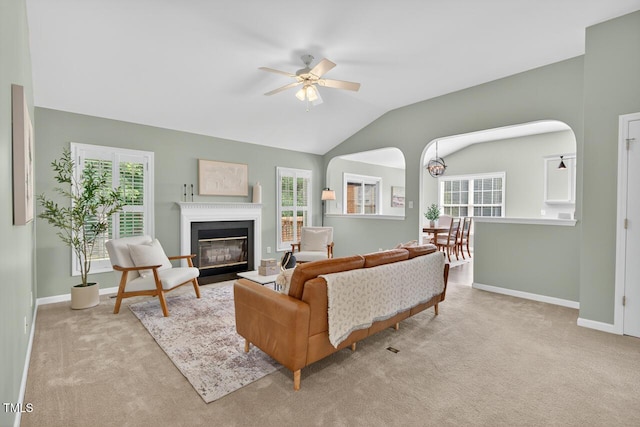 1004 Scotsburg Trl, Hillsborough, NC 27278 - carpeted living room with ceiling fan, healthy amount of natural light, a fireplace with flush hearth, vaulted ceiling, and arched walkways
