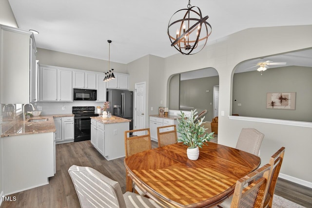 1004 Scotsburg Trl, Hillsborough, NC 27278 - dining space featuring dark wood-style flooring, arched walkways, ceiling fan, lofted ceiling, and a chandelier