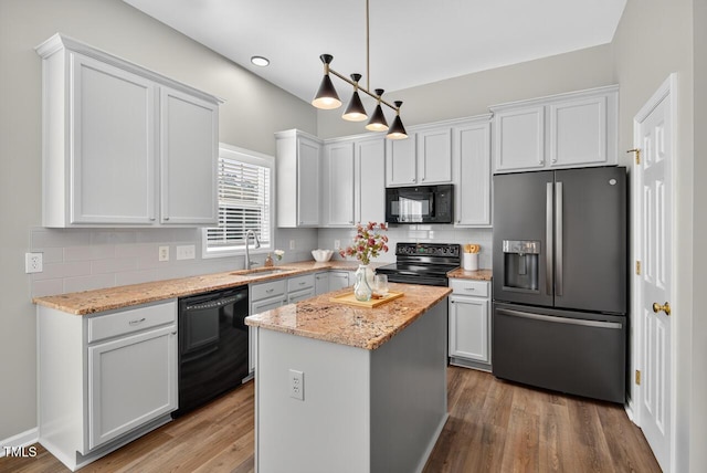 1004 Scotsburg Trl, Hillsborough, NC 27278 - kitchen featuring black appliances, tasteful backsplash, a kitchen island, light stone countertops, and recessed lighting