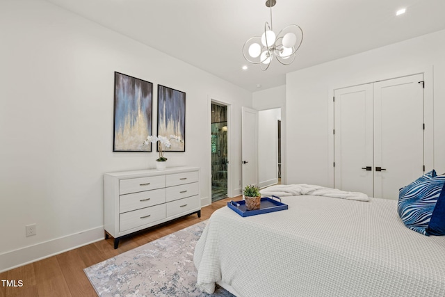 1616 Hunting Ridge Rd, Raleigh, NC 27615 - bedroom with a chandelier, wood finished floors, a closet, recessed lighting, and connected bathroom