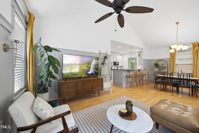 1010 S Person St, Raleigh, NC 27601 - living room featuring light wood-type flooring, a ceiling fan, a chandelier, and high vaulted ceiling