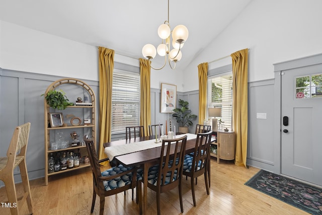 1010 S Person St, Raleigh, NC 27601 - dining room featuring a chandelier, lofted ceiling, light wood-style floors, and a decorative wall