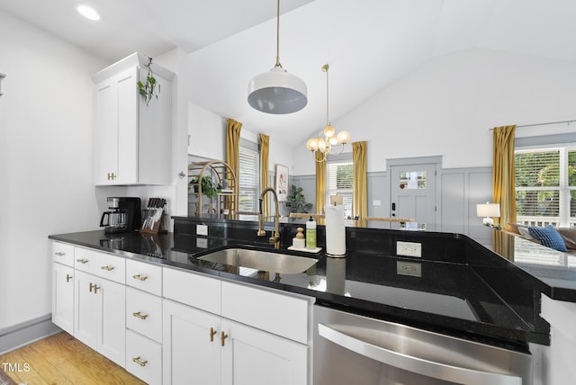 1010 S Person St, Raleigh, NC 27601 - kitchen featuring stainless steel dishwasher, vaulted ceiling, decorative light fixtures, dark stone countertops, and white cabinetry