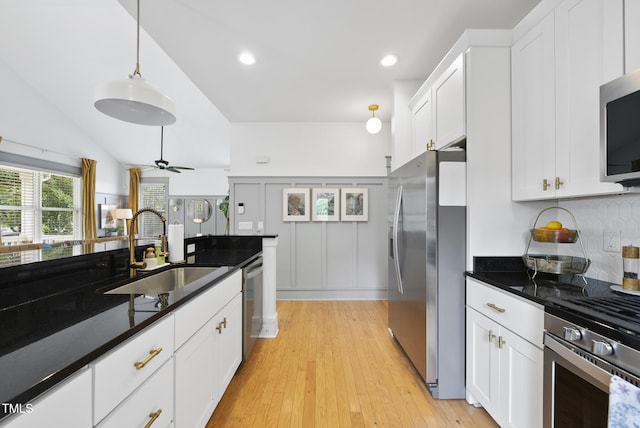 1010 S Person St, Raleigh, NC 27601 - kitchen featuring stainless steel appliances, tasteful backsplash, white cabinetry, ceiling fan, and light wood finished floors