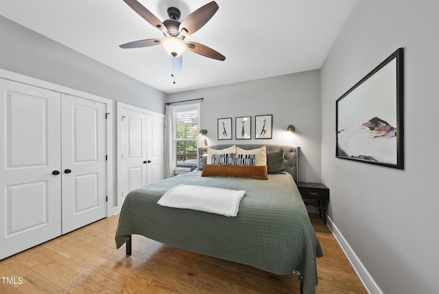 1010 S Person St, Raleigh, NC 27601 - bedroom featuring multiple closets, wood finished floors, and a ceiling fan