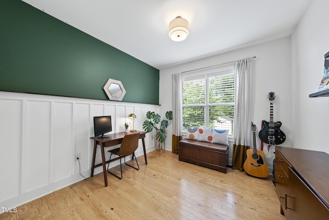 1010 S Person St, Raleigh, NC 27601 - home office featuring light wood finished floors, wainscoting, and a decorative wall