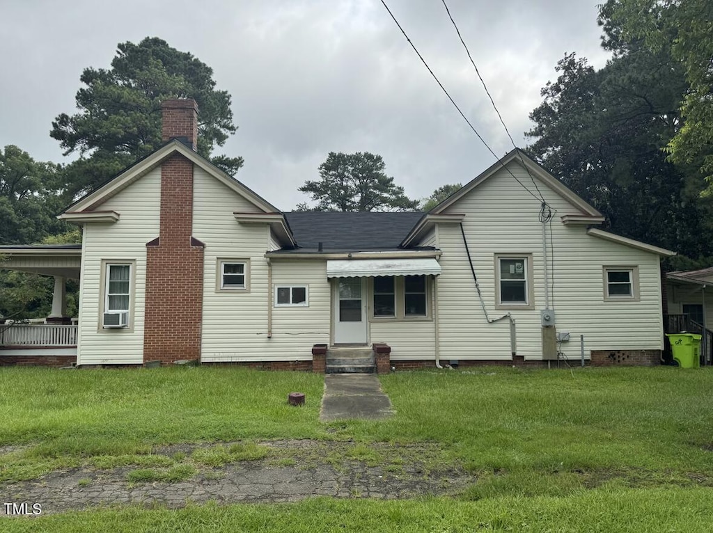 220 E Branch St, Spring Hope, NC 27882 - rear view of house featuring a yard, a chimney, and cooling unit