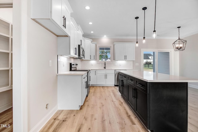 134 Cherrybirch Ln, Zebulon, NC 27597 - kitchen with stainless steel appliances, dark cabinets, white cabinetry, ornamental molding, and backsplash