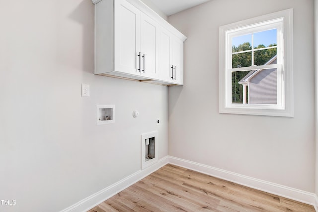 134 Cherrybirch Ln, Zebulon, NC 27597 - washroom featuring hookup for an electric dryer, cabinet space, light wood-style floors, hookup for a washing machine, and hookup for a gas dryer