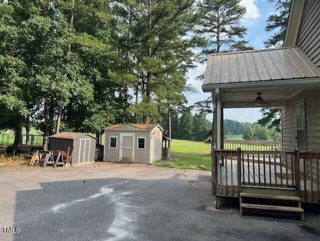 2856 Nutbush Rd, Henderson, NC 27537 - view of patio with a storage shed, a deck, and ceiling fan