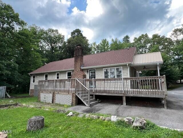 2856 Nutbush Rd, Henderson, NC 27537 - back of property with a wooden deck, a chimney, and a yard