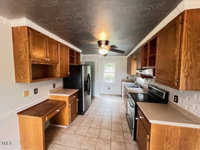 2856 Nutbush Rd, Henderson, NC 27537 - kitchen with open shelves, appliances with stainless steel finishes, brown cabinets, light tile patterned floors, and ornamental molding