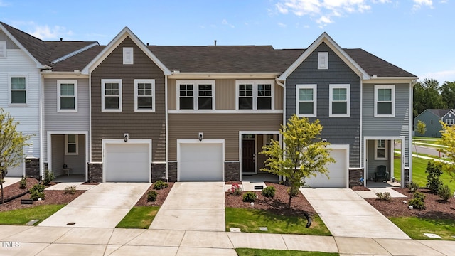 5721 Woodlawn Dr, Durham, NC 27703 - view of property with stone siding, concrete driveway, and a garage
