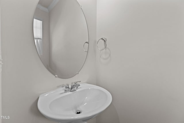 5721 Woodlawn Dr, Durham, NC 27703 - bathroom featuring a sink and crown molding