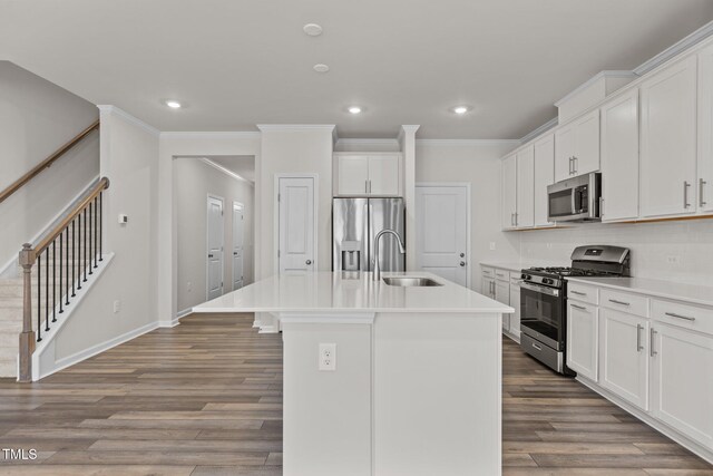 5721 Woodlawn Dr, Durham, NC 27703 - kitchen with stainless steel appliances, a center island with sink, recessed lighting, wood finished floors, and decorative backsplash