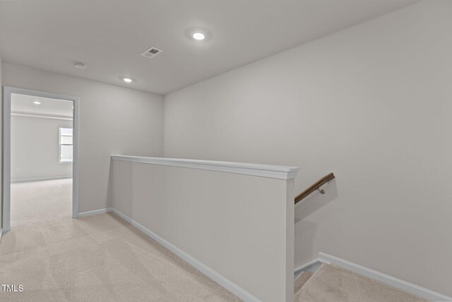 5721 Woodlawn Dr, Durham, NC 27703 - corridor with an upstairs landing, carpet flooring, and recessed lighting