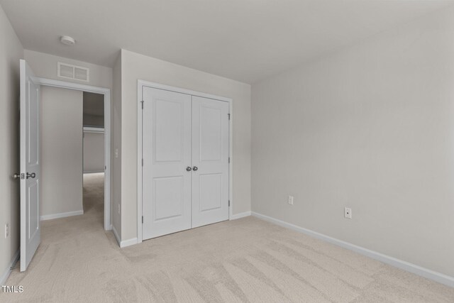 5721 Woodlawn Dr, Durham, NC 27703 - unfurnished bedroom featuring light colored carpet and a closet