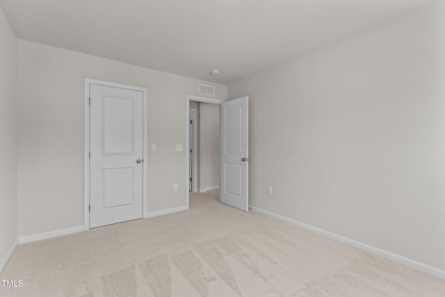 5721 Woodlawn Dr, Durham, NC 27703 - unfurnished bedroom featuring light colored carpet and baseboards