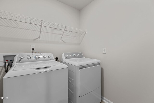 5721 Woodlawn Dr, Durham, NC 27703 - laundry area with washer and dryer and baseboards
