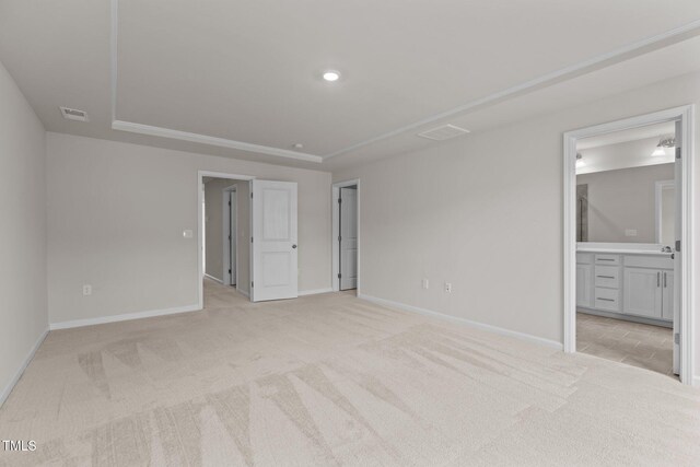5721 Woodlawn Dr, Durham, NC 27703 - unfurnished bedroom featuring light colored carpet and ensuite bathroom
